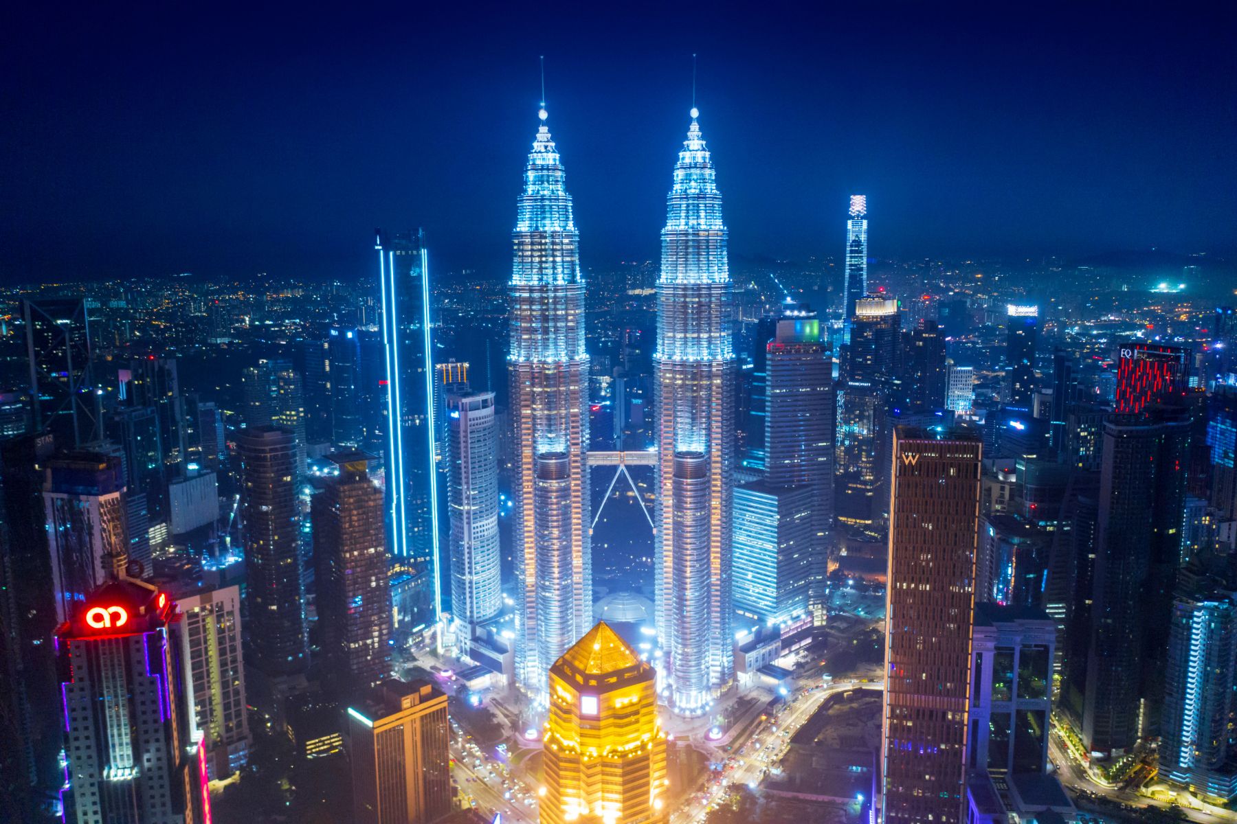 Night view of Petronas Towers and Kuala Lumpur cityscape in Malaysia - iconic landmarks and top tourist attractions.