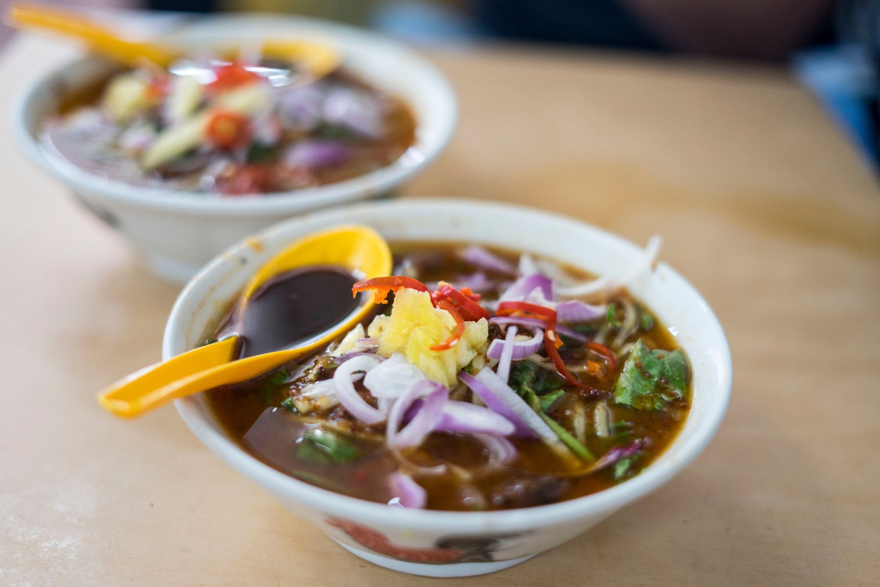 Penang Asam Laksa, a traditional Malaysian dish, famous for its rich flavors and unique ingredients - top food to try in Malaysia.