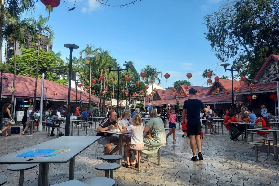 Diners enjoying food at an outdoor hawker centre in Singapore