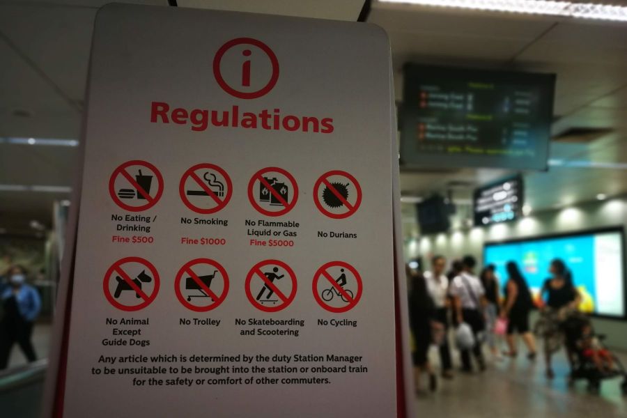A sign outlining key regulations and fines on the MRT Station in Singapore