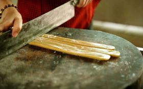 Watch skilled artisans craft Ben Tre coconut candy using traditional methods at a local workshop